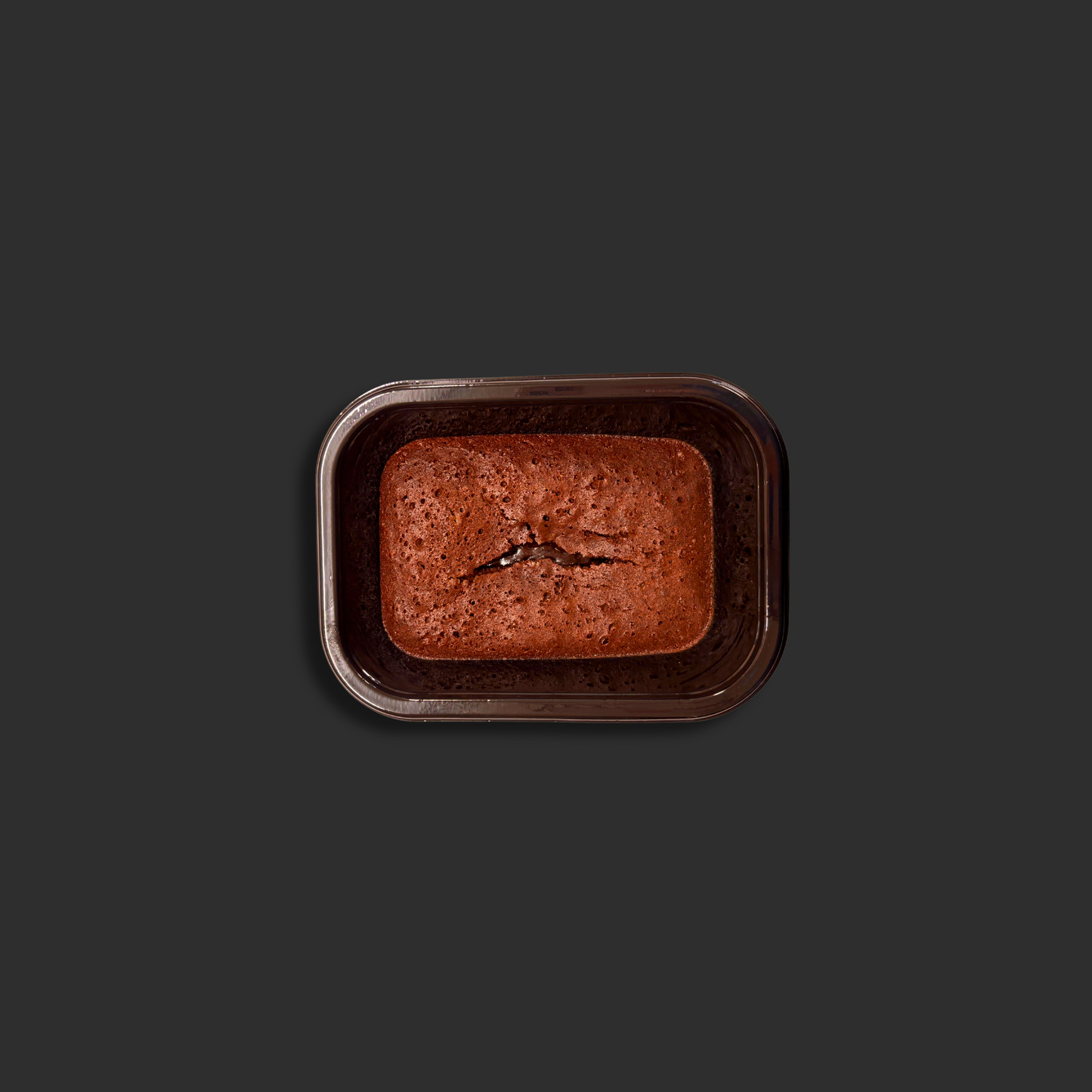 Chocolate fondant served in a black ready meal container, featuring the rich chocolate dessert with molten center