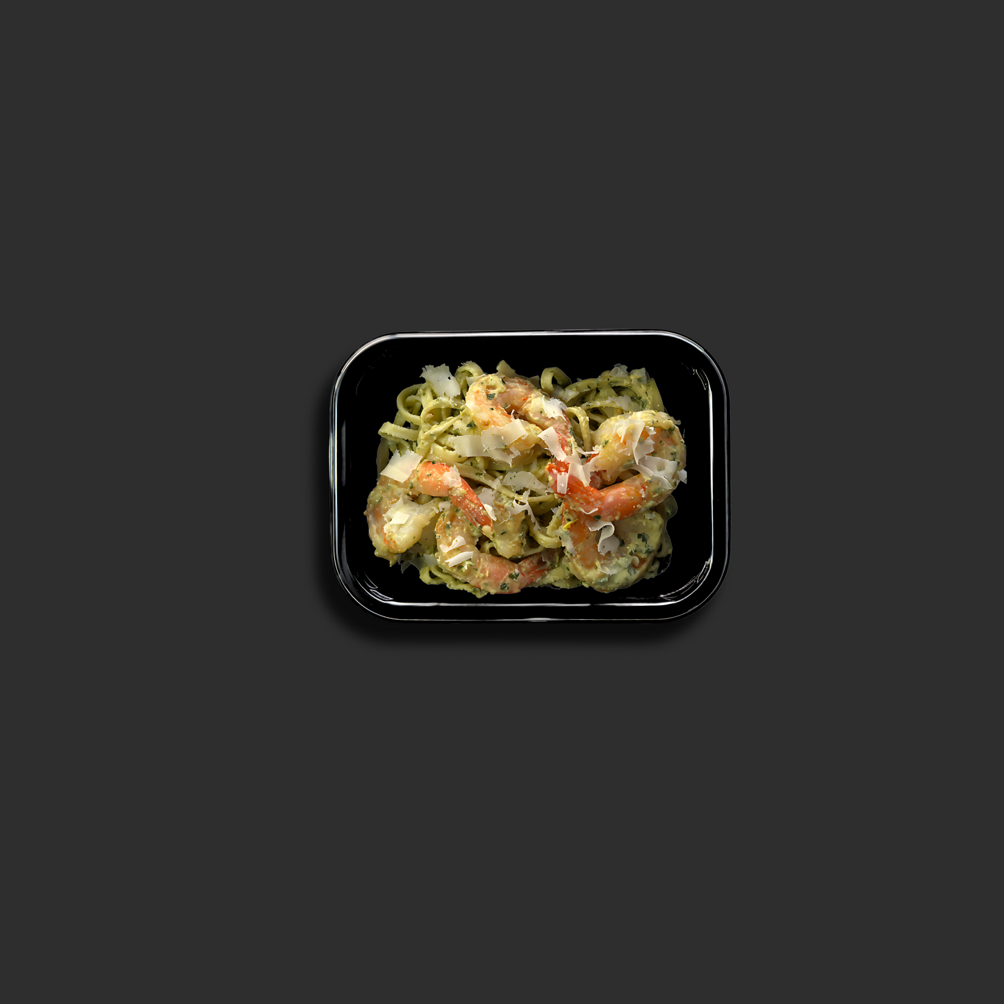 Fresh linguine with succulent prawns in creamy basil pesto sauce in a black ready meal container