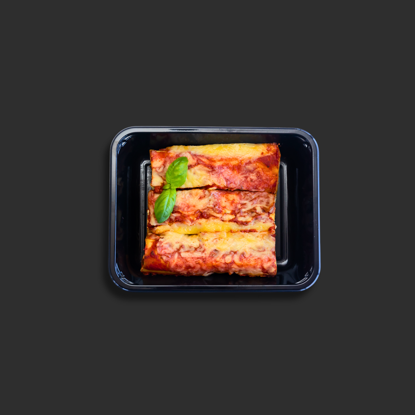 XChef Gourmet Spinach and Ricotta Cannelloni ready meal in black ready meal container with basil garnish