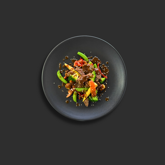 Mongolian Beef Stir Fry with tender beef strips, vegetables and savory sauce in a bowl