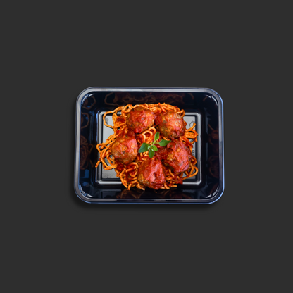 Spaghetti and meatballs Napolitana served in a black ready meal container with beef meatballs on top of pasta in Napolitana sauce and basil garnish